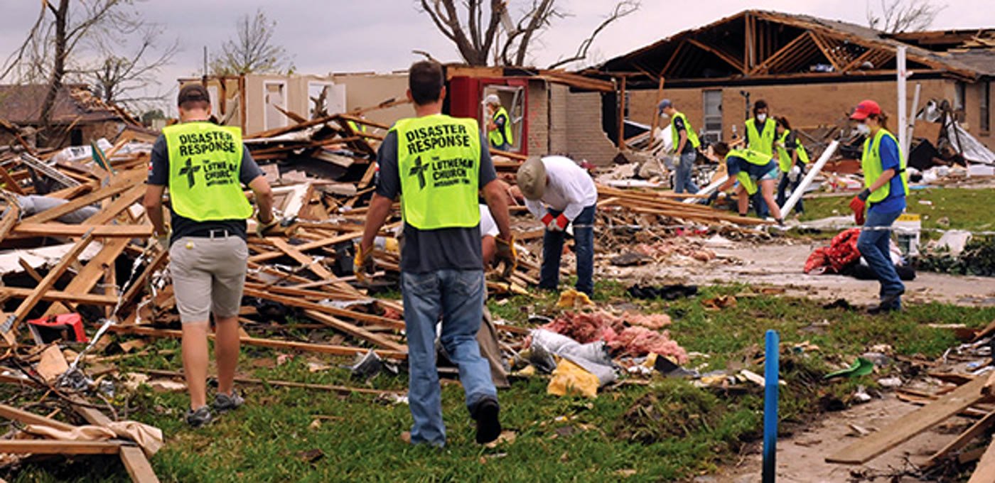 Volunteers in disaster-response vests moving through storm debris. Photograph hosted on the CRLT site.